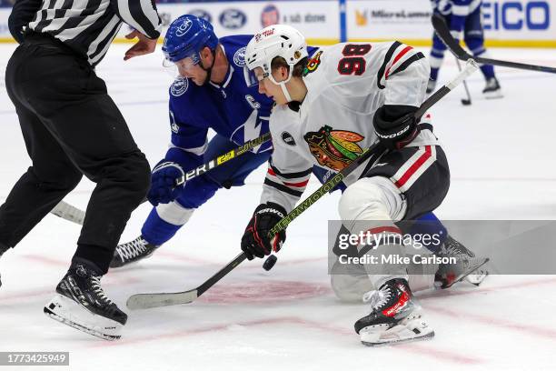 Connor Bedard of the Chicago Blackhawks faces off against Steven Stamkos of the Tampa Bay Lightning during the second period at the Amalie Arena on...