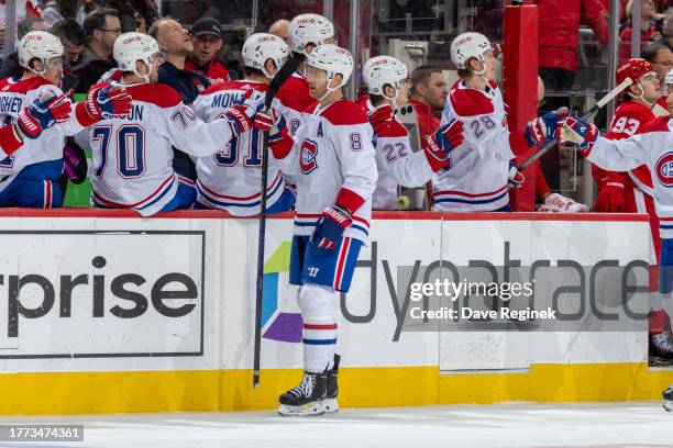 Mike Matheson of the Montreal Canadiens fist bumps with teammates after goal during the first period against the Detroit Red Wings at Little Caesars...