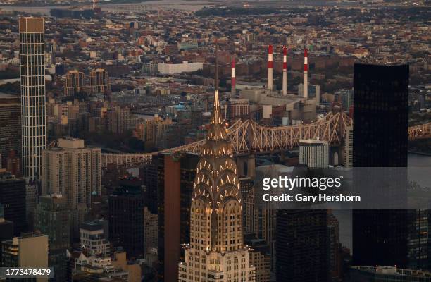 The sun sets on the Chrysler Building seen from the 102nd floor of the Empire State Building on November 2 in New York City.
