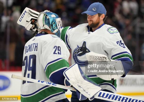 Thatcher Demko of the Vancouver Canucks congratulates Casey DeSmith after their teams' 5-2 win against the Ottawa Senators at Canadian Tire Centre on...