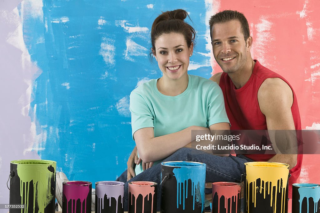 Couple with any cans of colorful paint
