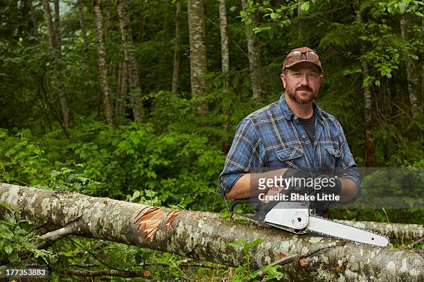 portrait with chainsaw - forestry worker stock pictures, royalty-free photos & images