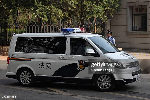 The police car transporting former Chinese politician Bo Xilai arrives at the Jinan Intermediate People's Court on August 23, 2013 in Jinan, China....