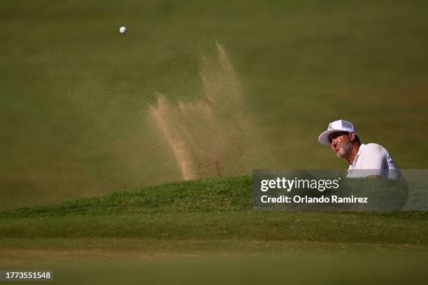 Scott Piercy of the United States plays a shot from a bunker on the first hole during the second round of the World Wide Technology Championship at...