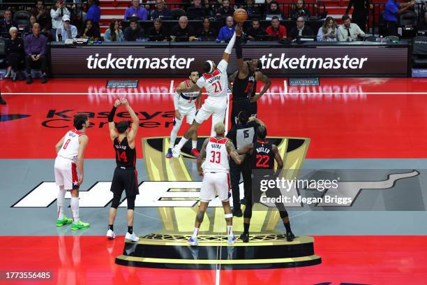 Daniel Gafford of the Washington Wizards and Bam Adebayo of the Miami Heat compete for the opening tip off in the first quarter during the NBA...