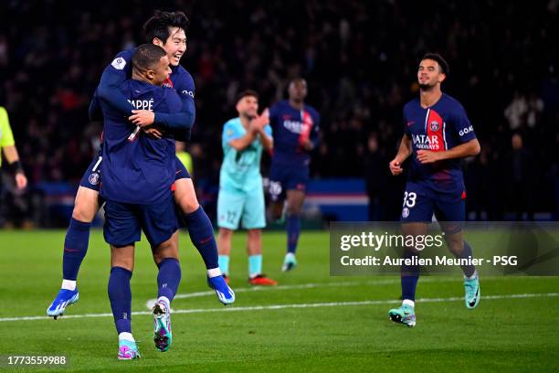 Lee Kang In of Paris Saint-Germain is congratulated by teammate Kylian Mbappe after scoring during the Ligue 1 Uber Eats match between Paris...