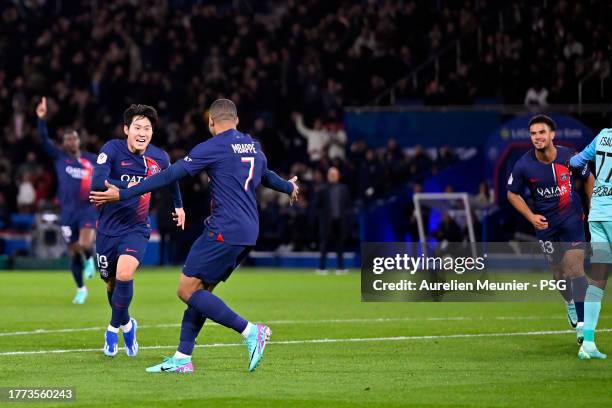 Lee Kang In of Paris Saint-Germain is congratulated by teammate Kylian Mbappe after scoring during the Ligue 1 Uber Eats match between Paris...