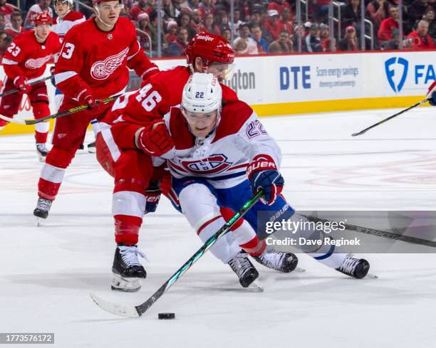 Cole Caufield of the Montreal Canadiens tries to skate around the defense of Jeff Petry of the Detroit Red Wings during the second period at Little...