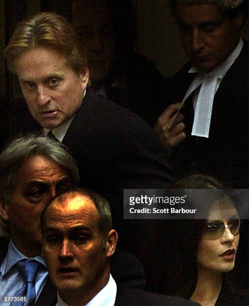 Actress Catherine Zeta-Jones and her husband, actor Michael Douglas , leave the Royal Courts of Justice after testifying February 10, 2003 in London....