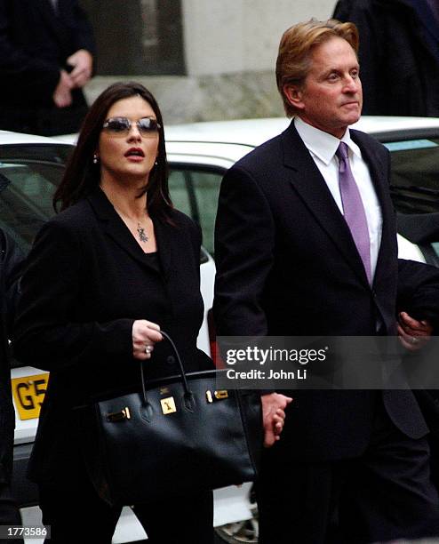 Actress Catherine Zeta-Jones and her husband, actor Michael Douglas, leave the Royal Courts of Justice after testifying February 10, 2003 in London....