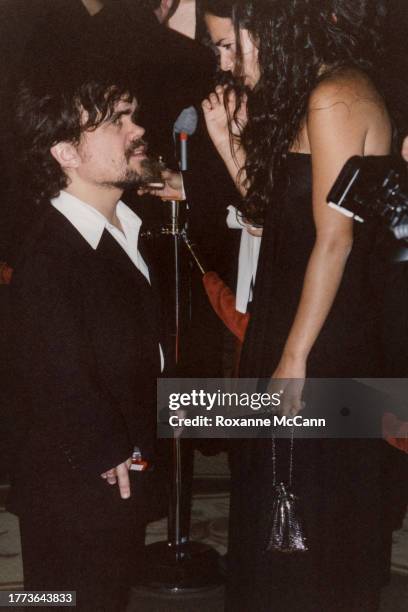 Peter Dinklage is surrounded by microphones, a camera and another guest as he arrives at the 56th Annual Directors Guild of America Awards at the...