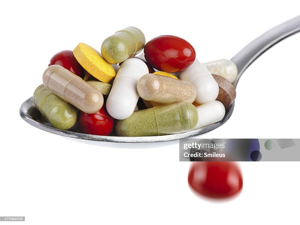 Spoon piled with pills