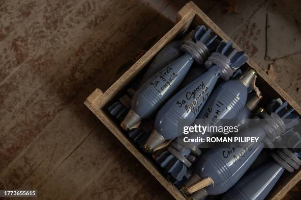 This photograph taken on November 6, 2023 shows mortar shells with the messages "For children and grandchildren", "For Odesa" written on them, at the...