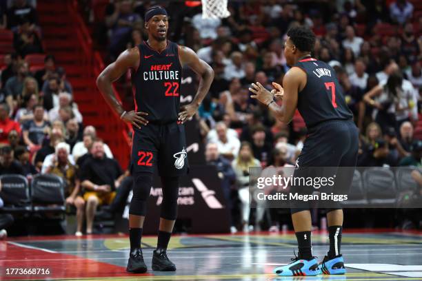 Jimmy Butler and Kyle Lowry of the Miami Heat speak on the court in the first quarter against the Washington Wizards during the NBA In-Season...