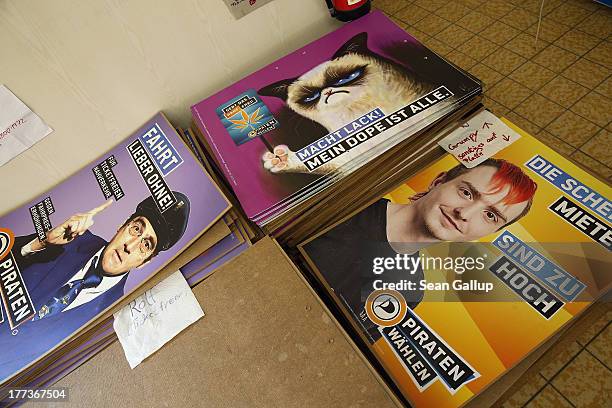 Election campaign posters of the German Pirates party , including one featuring Internet hit Grumpy the Cat, lie stacked at a Pirates district...