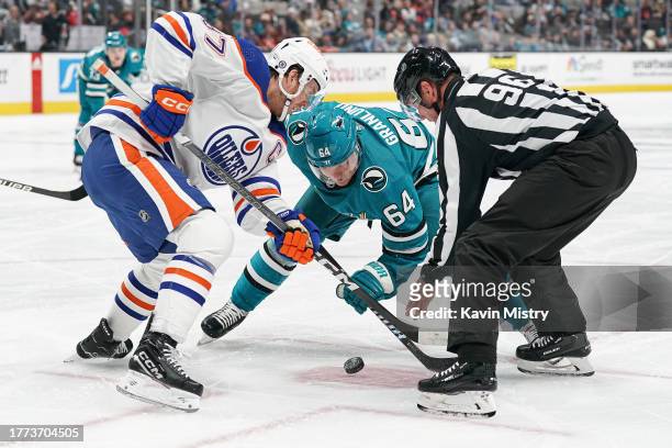 Connor McDavid of the Edmonton Oilers takes a face-off against Mikael Granlund of the San Jose Sharks at SAP Center on November 9, 2023 in San Jose,...