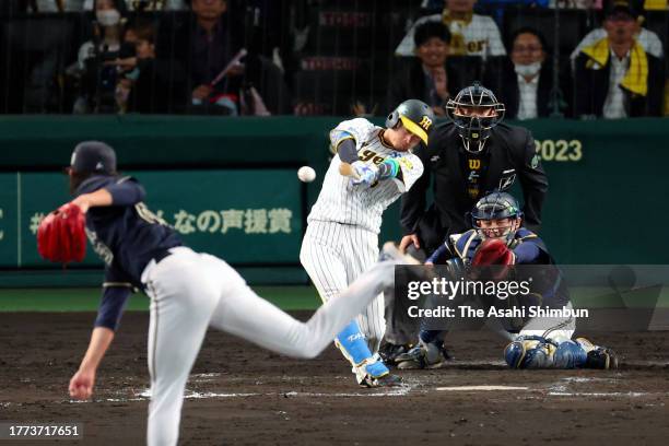 Koji Chikamoto of the Hanshin Tigers hits a RBI single in the 8th inning against Orix Buffaloes during the Japan Series Game Five at Hanshin Koshien...