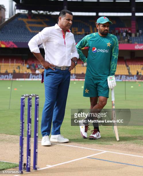 Babar Azam of Pakistan inspects the pitch alongside Waqar Younis ahead of the ICC Men's Cricket World Cup India 2023 between New Zealand and Pakistan...