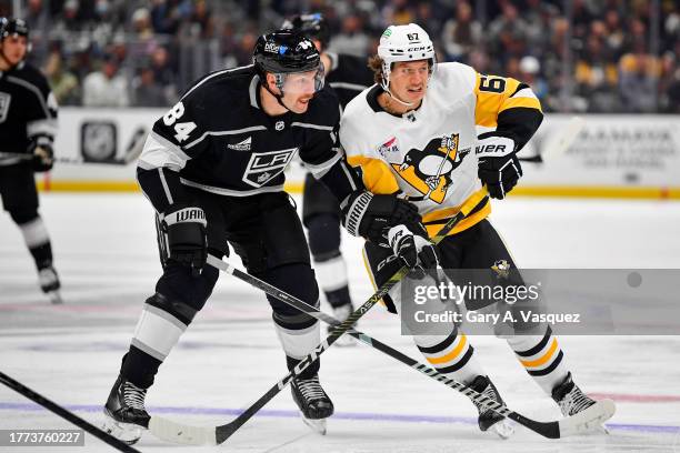 Vladislav Gavrikov of the Los Angeles Kings and Rickard Rakell of the Pittsburgh Penguins battle for position during the second period at Crypto.com...