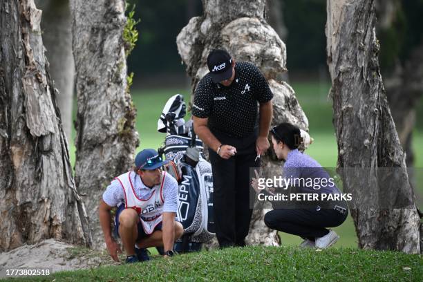 Patrick Reed of the US talks with a match referee on day two of the Hong Kong Open at Fanling golf club in Hong Kong on November 10, 2023.