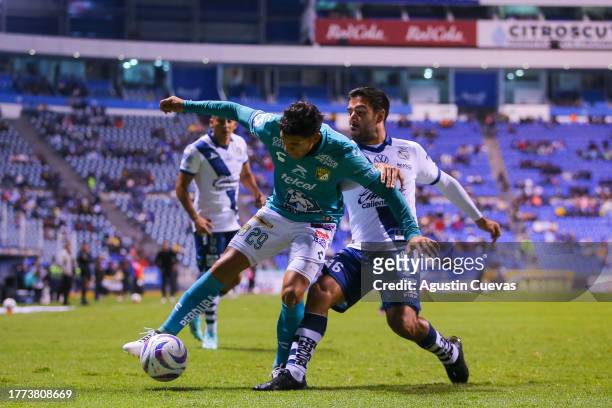 Lucas Romero of Leon fights for the ball with Pablo Gonzalez of Puebla during the 16th round match between Puebla and Leon as part of the Torneo...