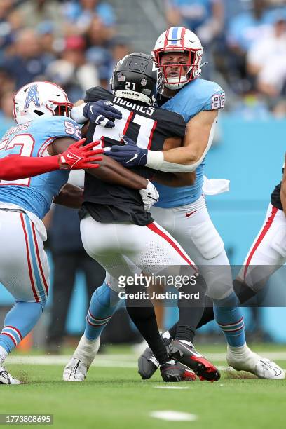 Kevin Rader of the Tennessee Titans tackles Mike Hughes of the Atlanta Falcons during the game at Nissan Stadium on October 29, 2023 in Nashville,...