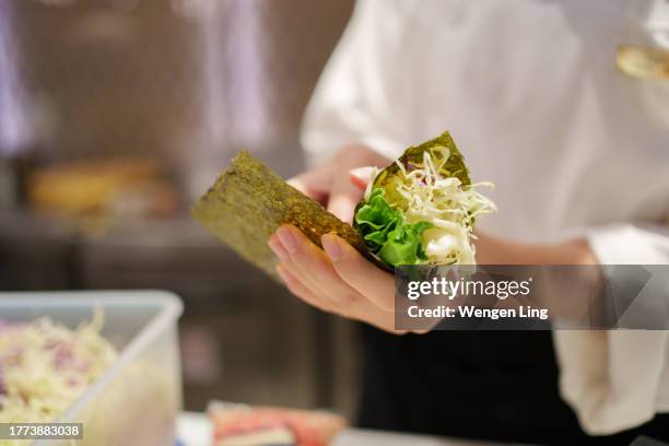 making hand-rolled sushi - hand roll stock pictures, royalty-free photos & images