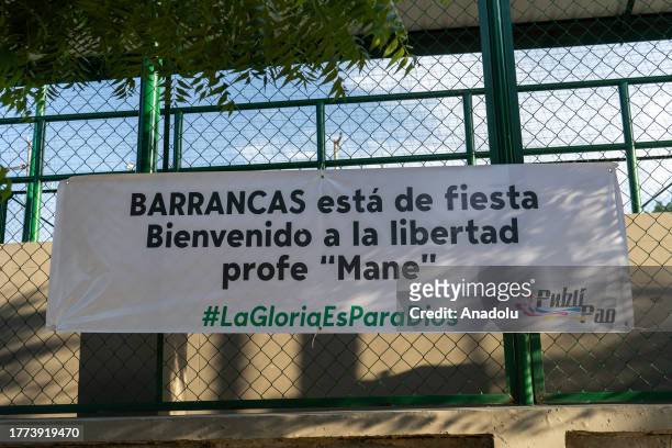 View of a banner as people wait in front of the house of Luis Manuel Diaz, father of Colombian footballer Luis Diaz, who plays for the English...