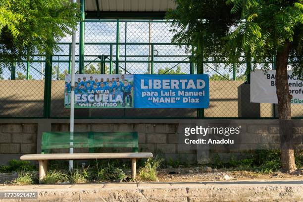View of a banner as people wait in front of the house of Luis Manuel Diaz, father of Colombian footballer Luis Diaz, who plays for the English...