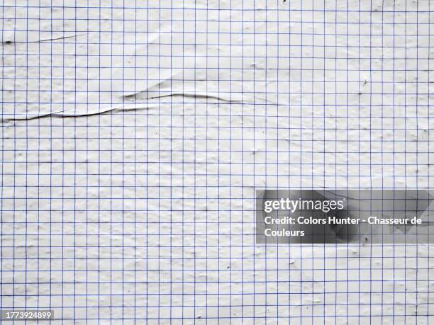 close-up of a sheet of graph paper glued and folded on a textured wall in paris, france - blueprint texture stock pictures, royalty-free photos & images