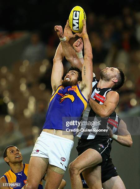 Josh Kennedy of the Eagles marks infront of Nathan Brown of the Magpies during the round 22 AFL match between the Collingwood Magpies and the West...