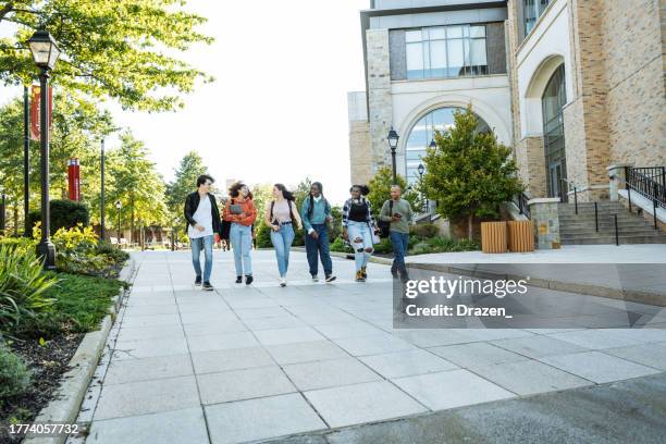group of diverse hispanic, american and african students in campus outdoors, walking together and talking - campus imagens e fotografias de stock