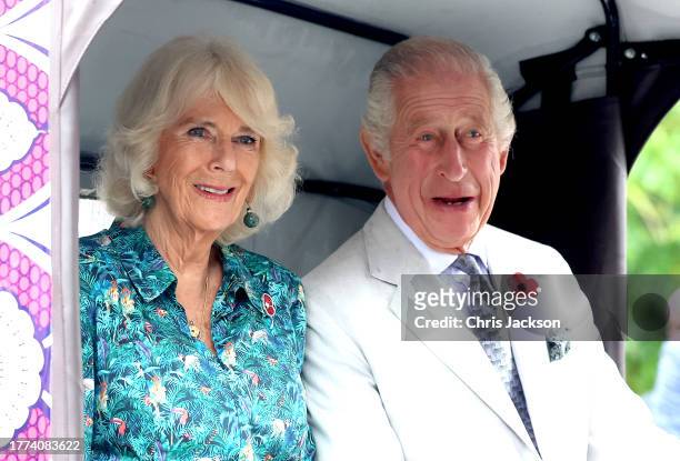 Queen Camilla and King Charles III smile as they sit in an electric tuk-tuk during a visit to Fort Jesus, the UNESCO World Heritage Site, where they...