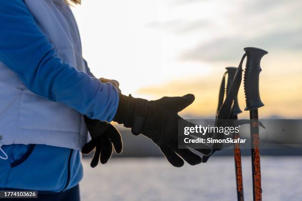 woman skier about to pick up her ski poles - woman on ski lift stock pictures, royalty-free photos & images