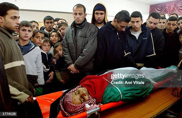 The Palestinian family of Emad Mabrouk mourns his death on the eve of the Muslim holiday of Eid al-Adha February 10, 2003 in the West Bank city of...