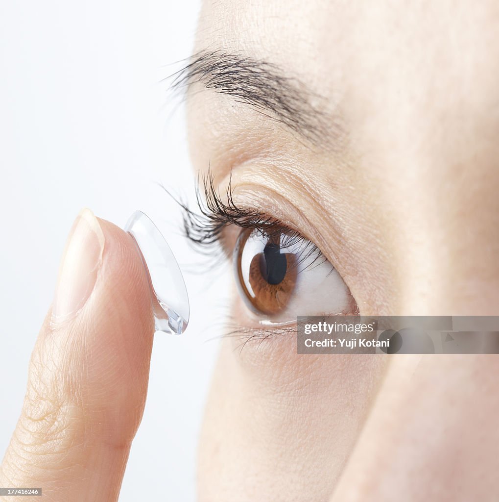 Eyes of the woman who is going to attach a contact