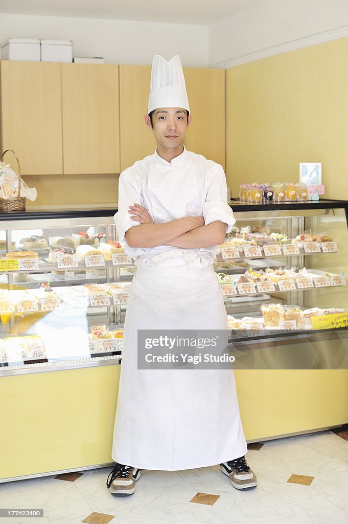 Pastry Chef standing in cake shop