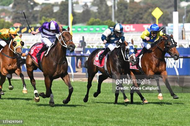 James McDonald riding Riff Rocket defeats Mark Zahra riding Apulia and John Allen riding Sunsets in Race 7, the Penfolds Victoria Derby, during Derby...