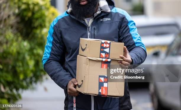 An Amazon.com Inc. Employee delivers parcels in Croydon, UK, on Thursday, Nov. 9, 2023. Amazon has been working to better target customers outside of...