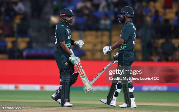 Babar Azam and Fakhar Zaman of Pakistan interact during the ICC Men's Cricket World Cup India 2023 between New Zealand and Pakistan at M. Chinnaswamy...