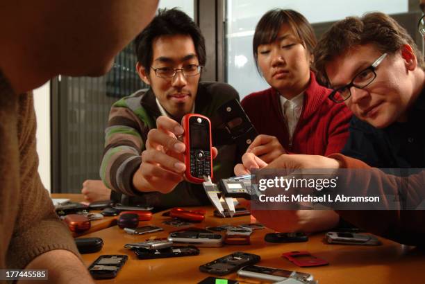 Designers tinkering with Motorola cell phones, October 24, 2005.