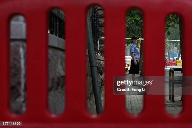 Chinese police woman guards outside the gate of the Jinan Intermediate People's Court on August 23, 2013 in Jinan, China. Ousted Chinese politician...