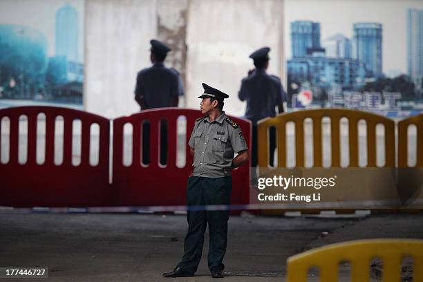 Chinese policemen guard outside the Jinan Intermediate People's Court on August 23, 2013 in Jinan, China. Ousted Chinese politician Bo Xilai is...