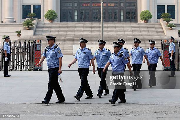 Chinese policemen guard outside the Jinan Intermediate People's Court on August 23, 2013 in Jinan, China. Ousted Chinese politician Bo Xilai is...