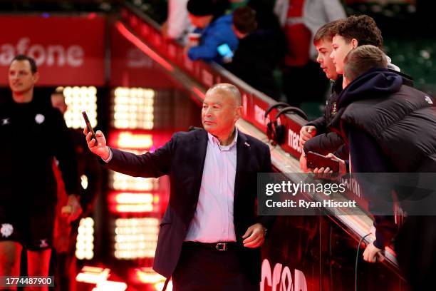 Eddie Jones, Coach of Barbarians, poses for a photograph with young fans prior to the Test Match between Wales and Barbarians at Principality Stadium...