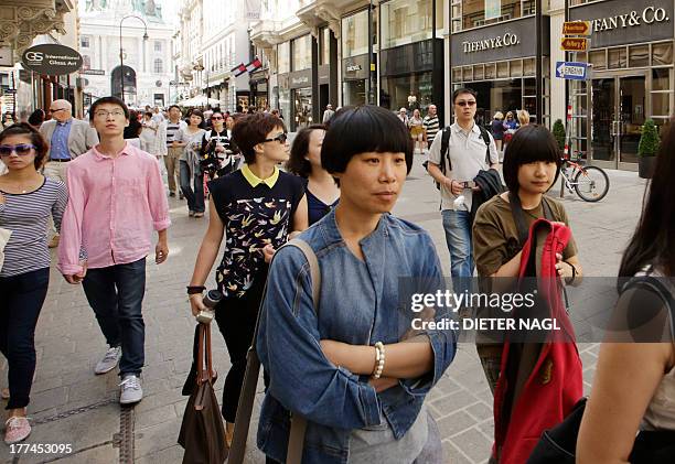 By Sim-Sim Wissgott Tourists pass in front of a store of US American luxury brand "Tiffany&Co" in "Kohlmarkt" street in the center of Vienna, Austria...