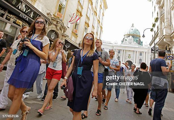 By Sim-Sim Wissgott Tourists pass in front of a store of Austrian jewellery brand "ANNA" in "Kohlmarkt" street in the center of Vienna, Austria on...