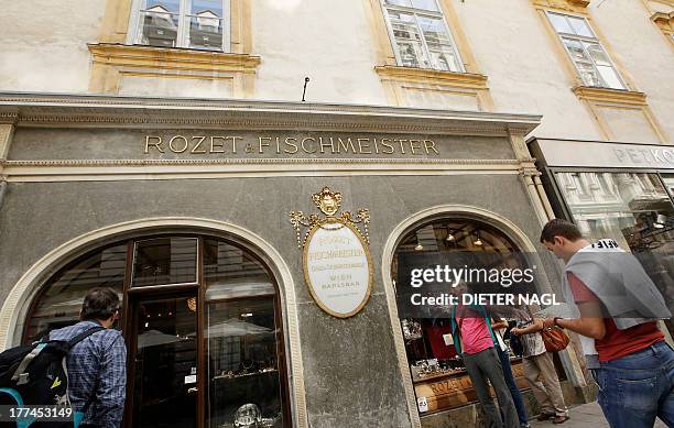 By Sim-Sim Wissgott Tourists stop in front of Austrian jewellery store "Rozet & Fischmeister" in "Kohlmarkt" street in the center of Vienna, Austria...