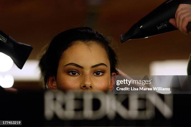 Model prepares backstage ahead of the MBFWA Trends show during Mercedes-Benz Fashion Festival Sydney 2013 at Sydney Town Hall on August 23, 2013 in...