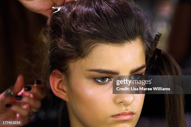 Model prepares backstage ahead of the MBFWA Trends show during Mercedes-Benz Fashion Festival Sydney 2013 at Sydney Town Hall on August 23, 2013 in...